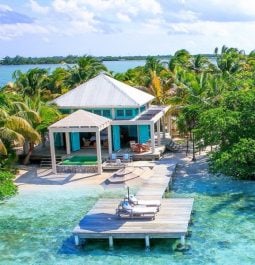 Small beachfront villa with private dock over turquoise clear water