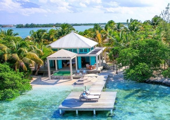 Small beachfront villa with private dock over turquoise clear water