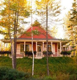 pink cottage through wooded trees