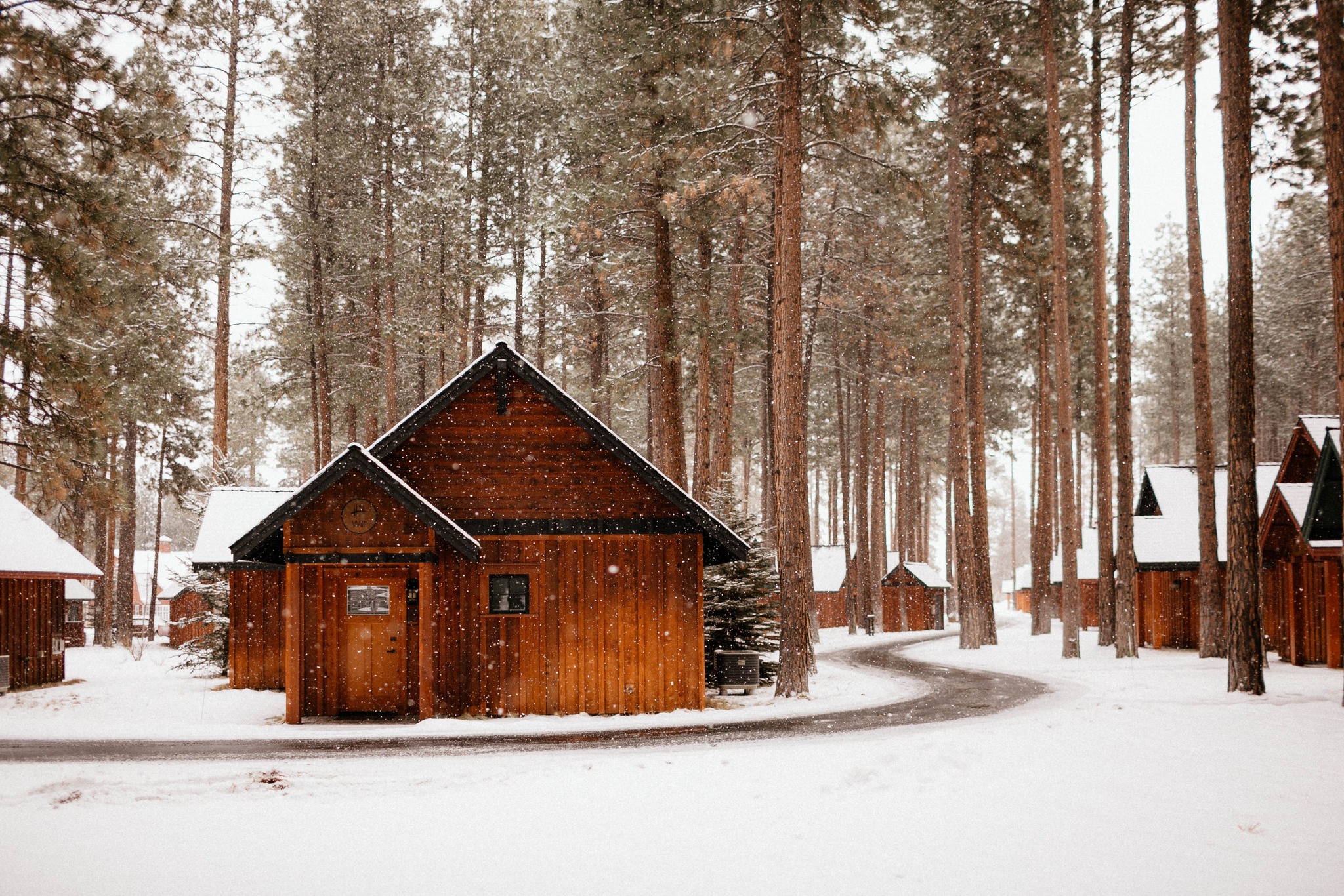 Snow falling down on cabins at FivePine Lodge