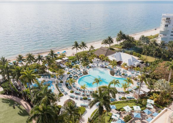 aerial view of beachfront resort pool complex