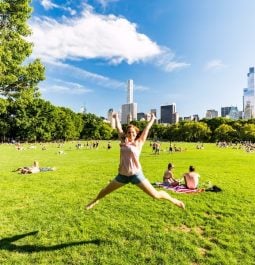 girl jumping for photo in central park