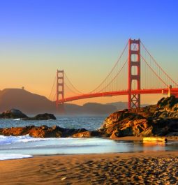 Beach in foreground with Golden Gate Bridge in distance