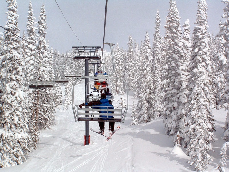 Chairlift carrying people up ski mountain