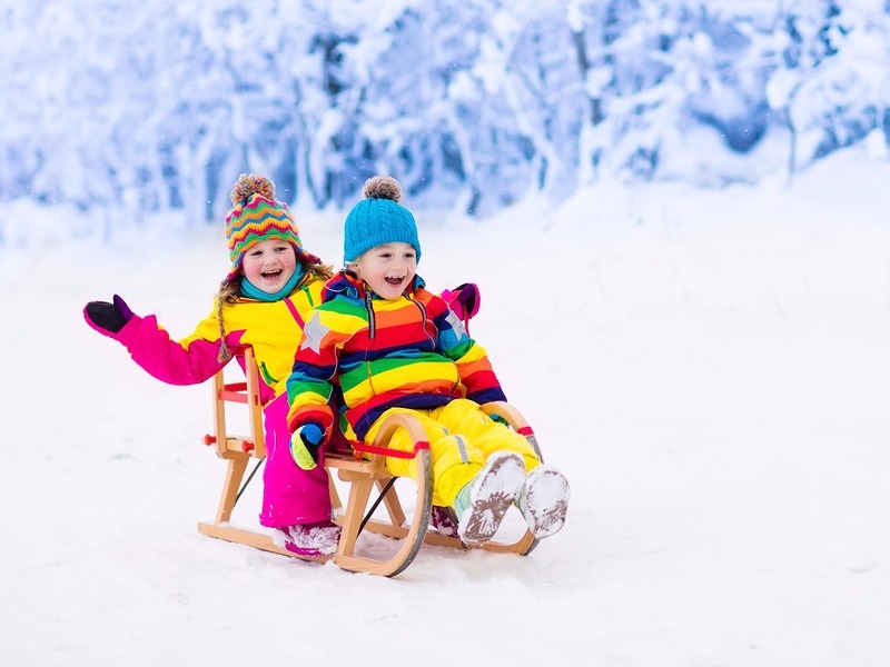 Boy and girl sledding