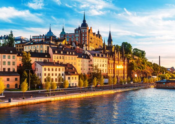 river next to European city skyline with historic buildings