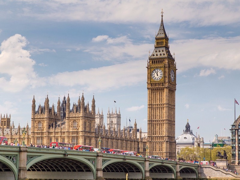 London buses crossing Westminster Bridge near Parliament