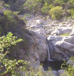 Rocky river leading to small waterfall