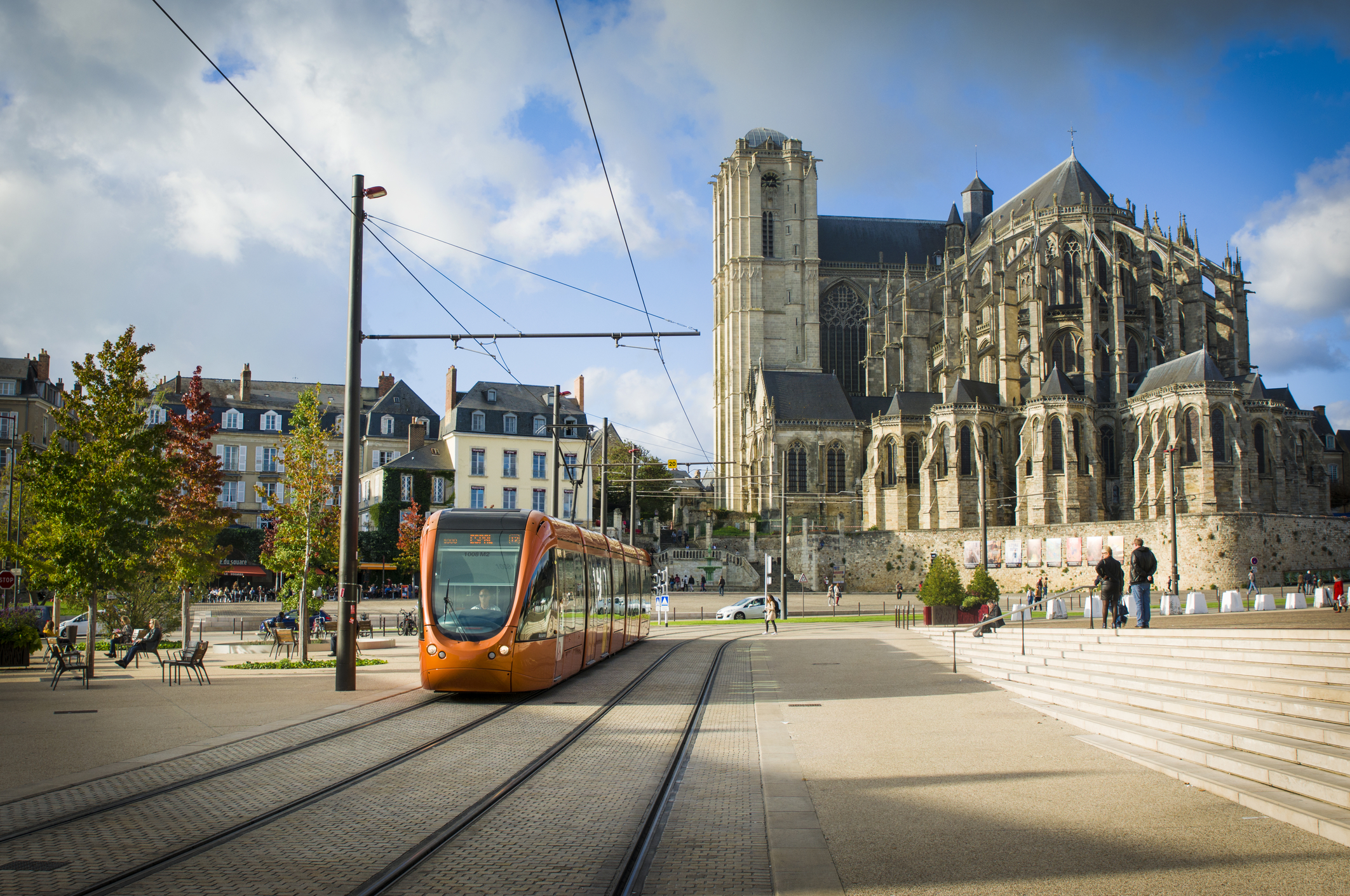 Le mans, FranceRoman cathedral of Saint Julien with an orange tram at a Le mans, France