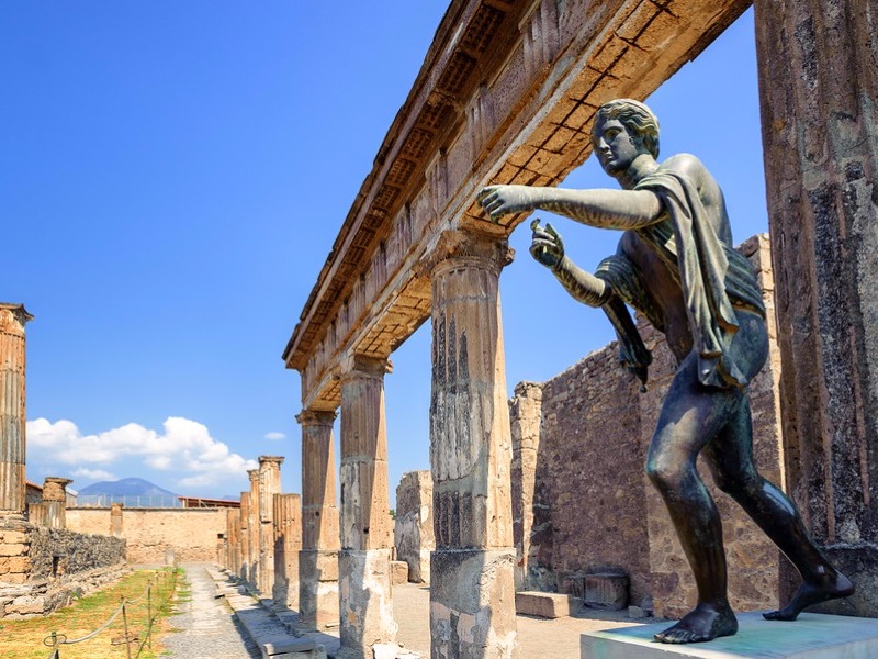 Ruins of the antique Temple of Apollo with bronze Apollo statue in Pompeii 