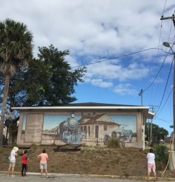 people looking at nature mural from the street view