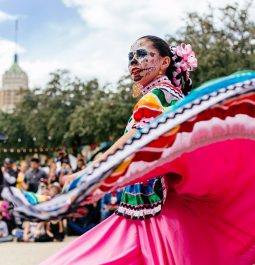 woman dressed in colorful dress at dia de los muertos