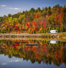 blanket of fall foliage reflected off of lake