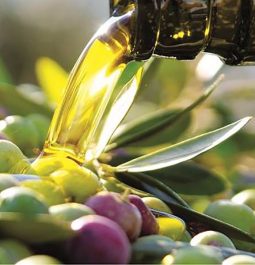 pouring olive oil onto olives