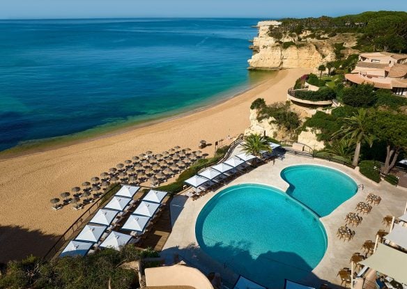 pool and beach with lounge chairs lined up