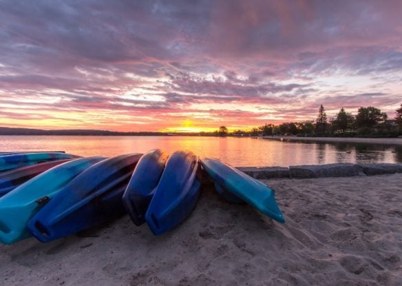 kayaks on water at sunset