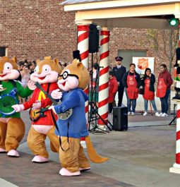 characters outside candy cane poles