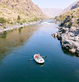 three people boating and fishing along the river in Hells Canyon