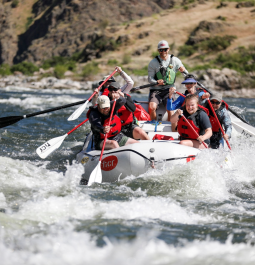 a group of people whitewater river rafting along Hells Canyon Gorge