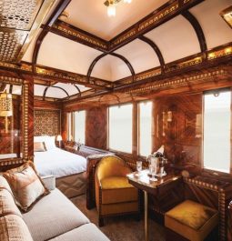 luxury train car with bed, couch, and table