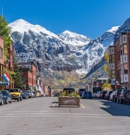 Snowcapped mountains peek over the downtown streets of charming Telluride, Colorado