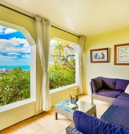 balcony with blue couches overlooking water