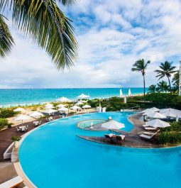 blue rounded pool with island lounge chairs in middle