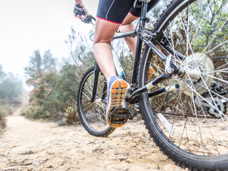 Woman making downhill with mountain bik