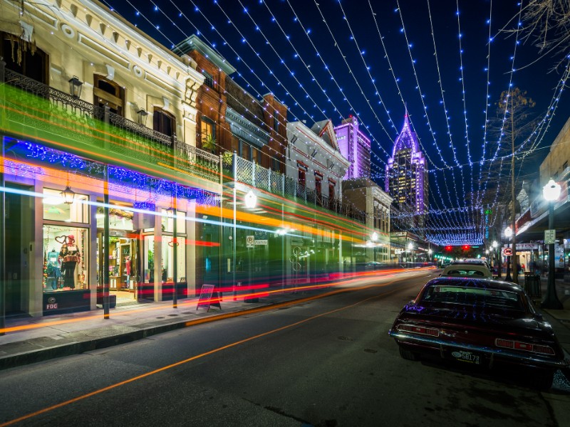 String lights hung over Dauphin Street, and buildings in downtown Mobile, Alabama