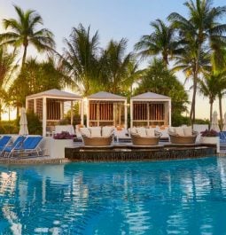 pool at sunset with chairs and tents