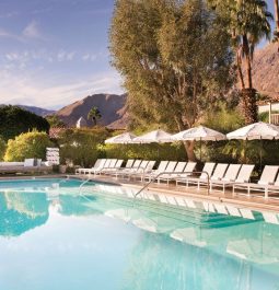 hotel pool lined with lounge chairs