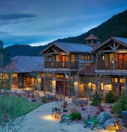 lit up cabin with mountain in background