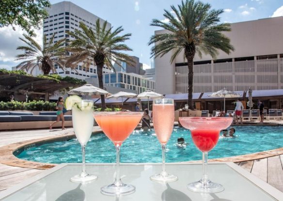 four drinks lined up along pool