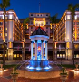 luxury hotel illuminated at night with fountain in front