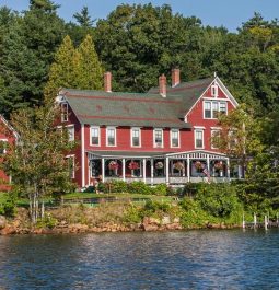 waterfront red lake house surrounded by trees