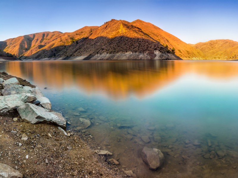 The first light of the sun hits the mountains in Lucky Peak State Park