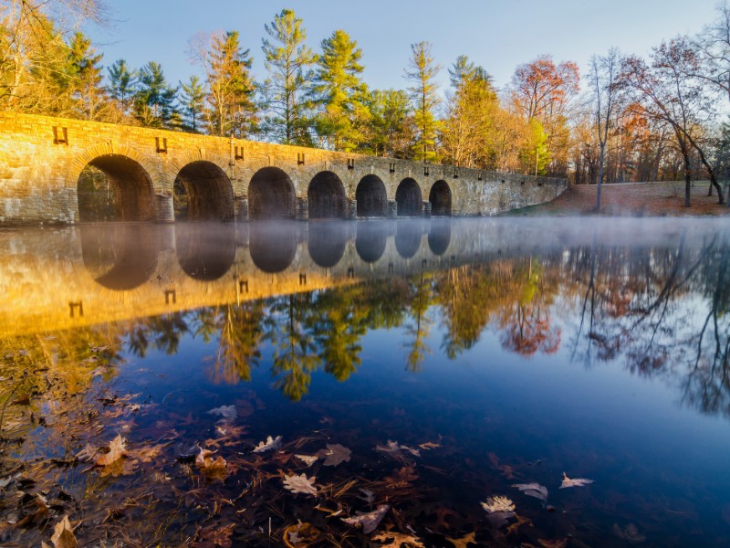 Fog and morning light on this fall scene on Byrd Lake Dam at Cumberland Mountain State Park