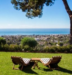 lounge chairs on the lawn overlooking the ocean