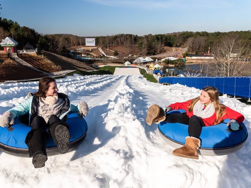 Friends on snow tubes