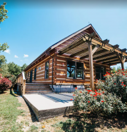 A private log cabin with lush landscaping and mountain views in Georgia