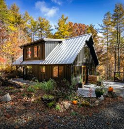 A-frame cabin on a clearing in the fall woods