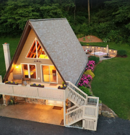 A-frame cabin lit up at night