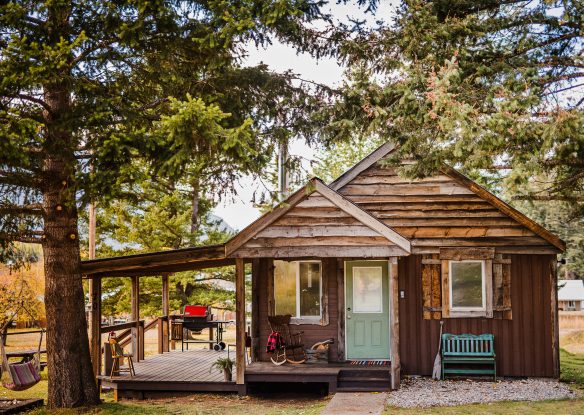 side view of wood cabin with front porch and outdoor area