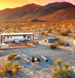 Dramatic sunset scene with aerial view of camper