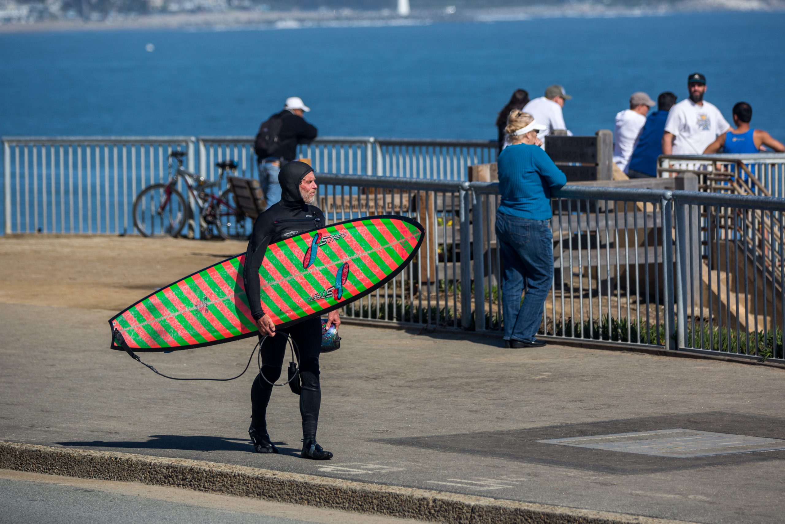 Surfer carrying board near famous Santa Cruz surfing spot