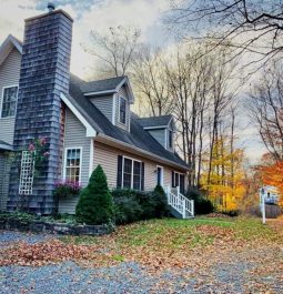 Side exterior view of the home with fall leaves