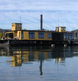 A historic yellow ferryboat sits in the harbor in Sausalito, California