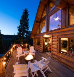 View of the deck with a fire pit at Log Cabin on the River with a Hot Tub