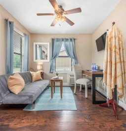 Living room view with blue decor and ceiling fan