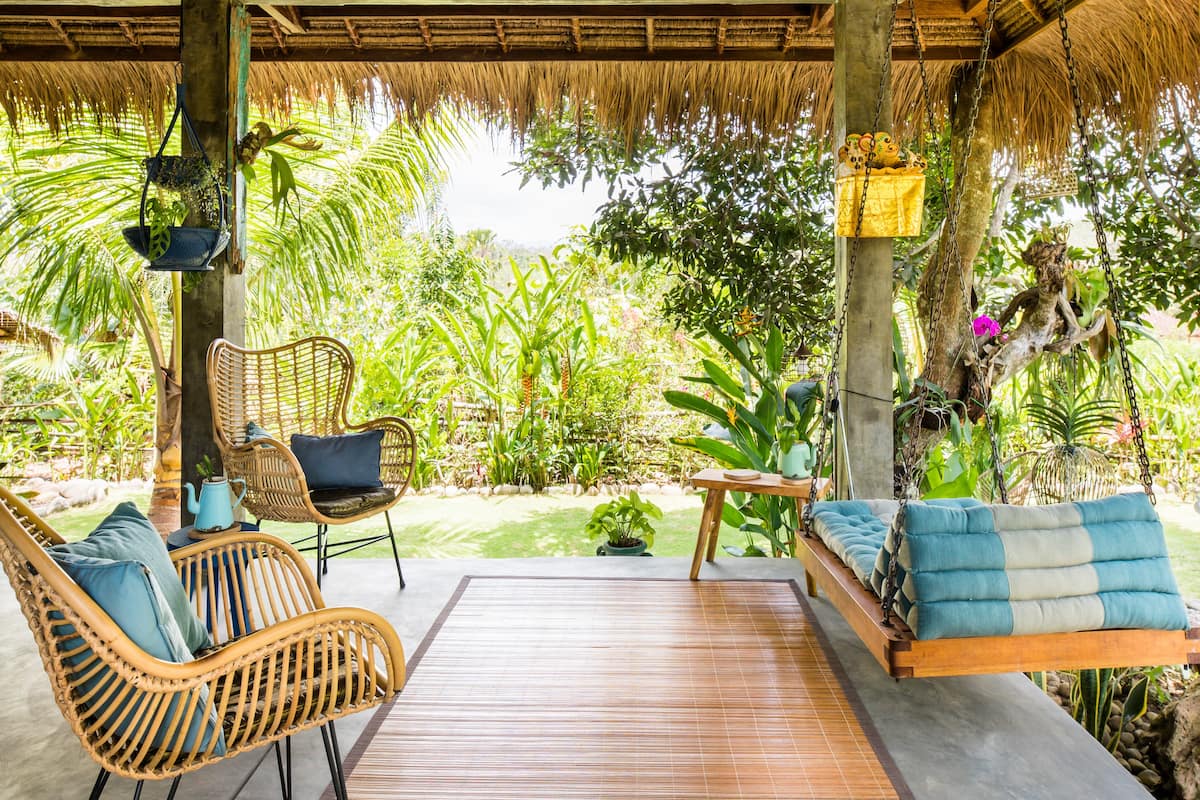 Living area with jungle backdrop at The Writers' Treehouse